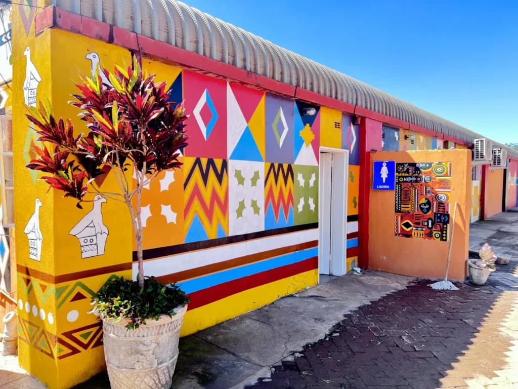 Ndebele patterns and bird motifs along the walkway